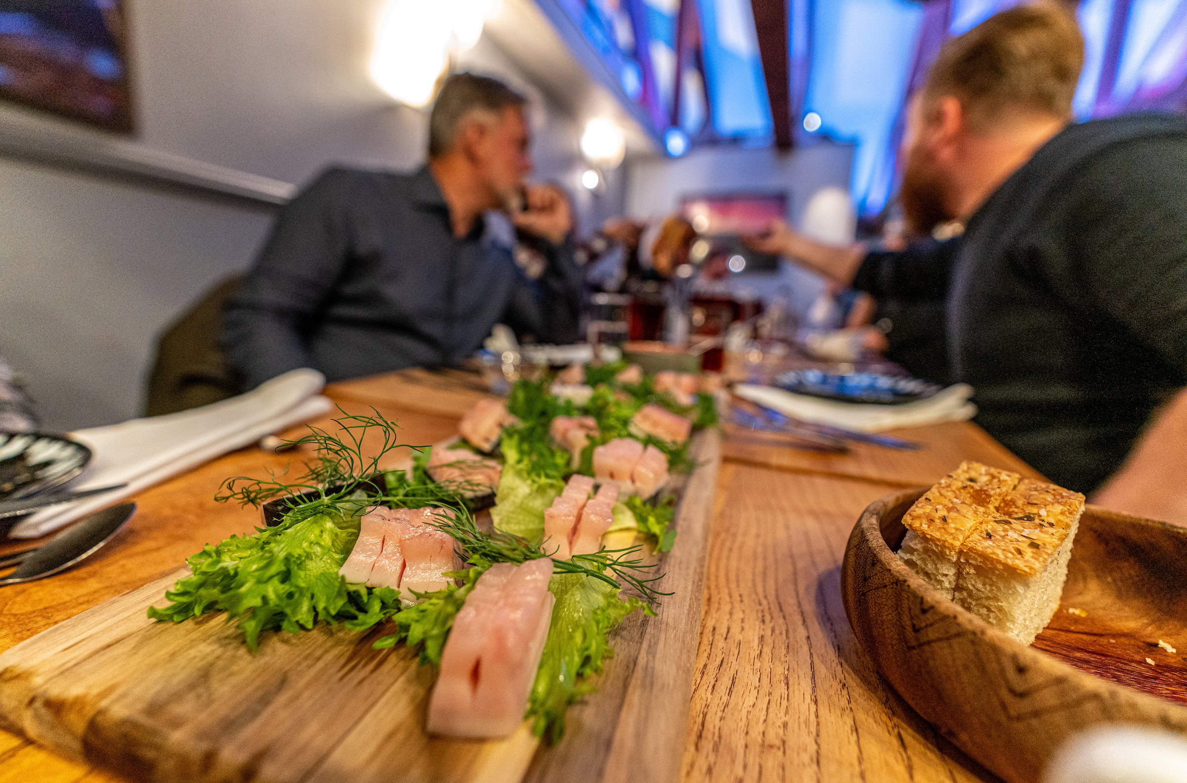 Exploring the many great restaurants in Nuuk, where you should try Mattak. Photo by Henrik Møller Nielsen - Visit Greenland