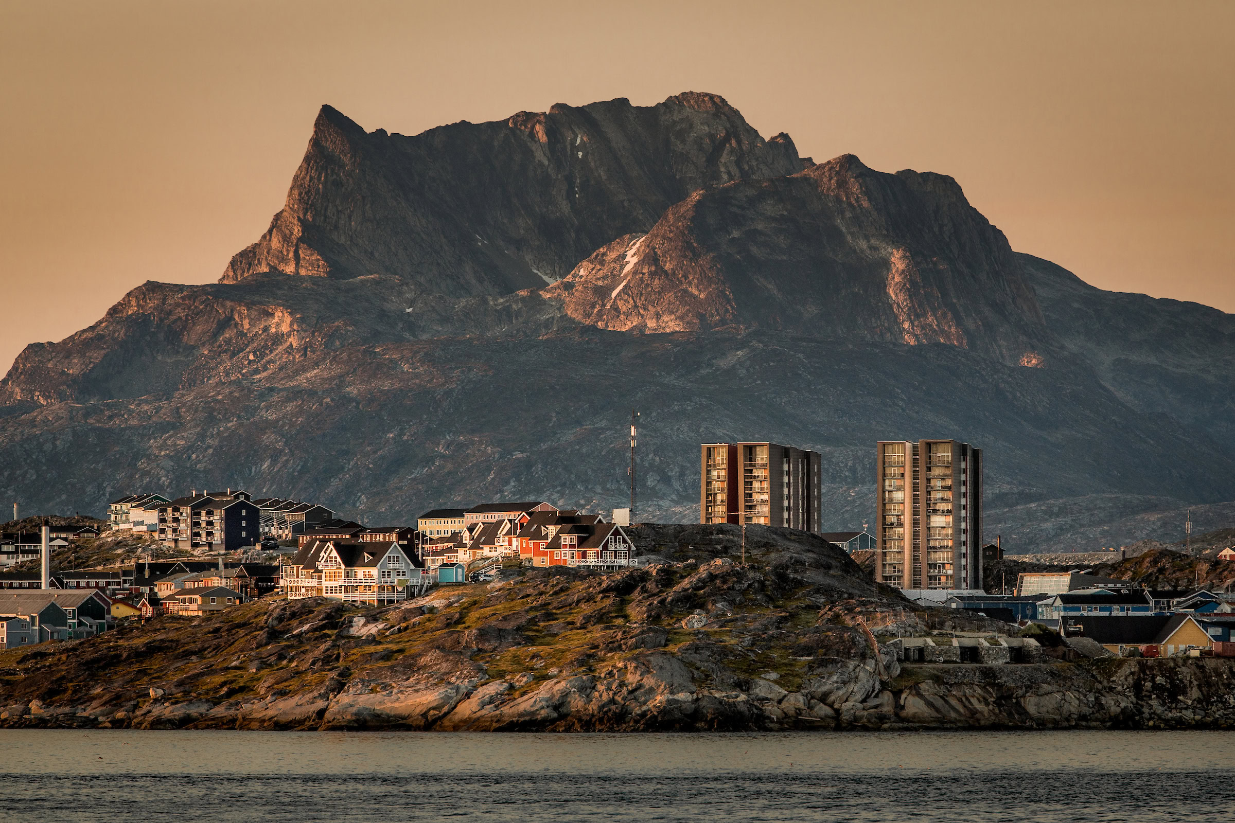 Buildings in Nuuk with the mountain Sermitsiaq in the background at sunset in Greenland - Visit Greenland photo database