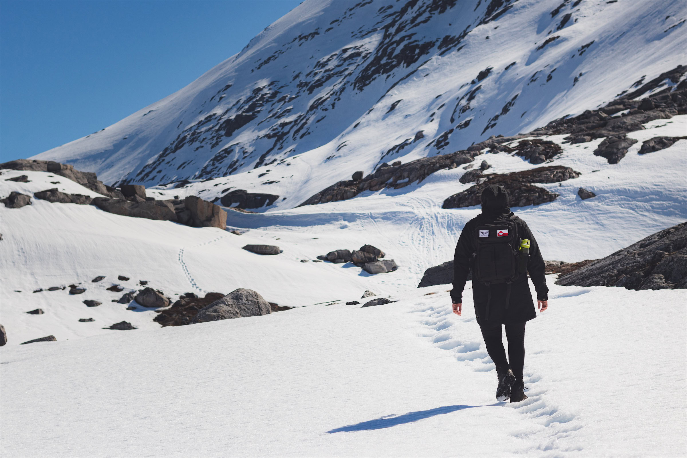 Person hiking in snowy hills of Nuuk. Photo - Magnus Biilmann Trolle, Visit Nuuk