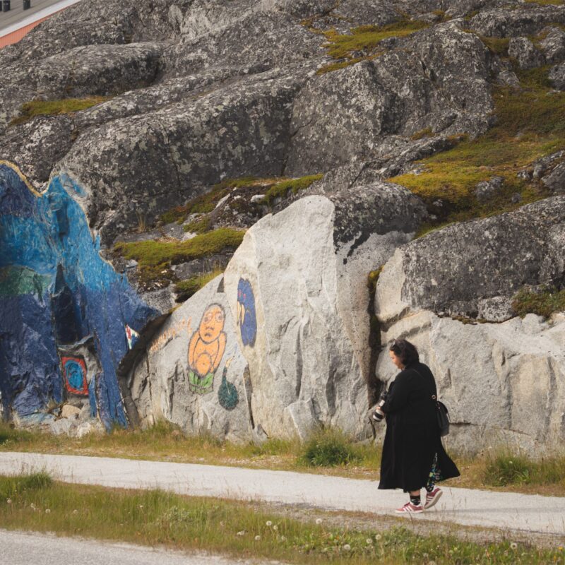 art-on-a-hill-wit-person-walking. Photo - Magnus Biilmann Trolle, Visit Nuuk