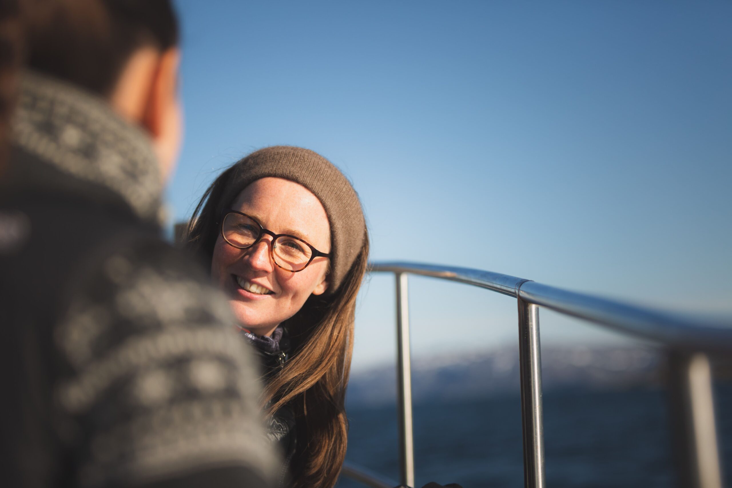 millenial-woman-smiling-on-boat-in-nuuk-fjord