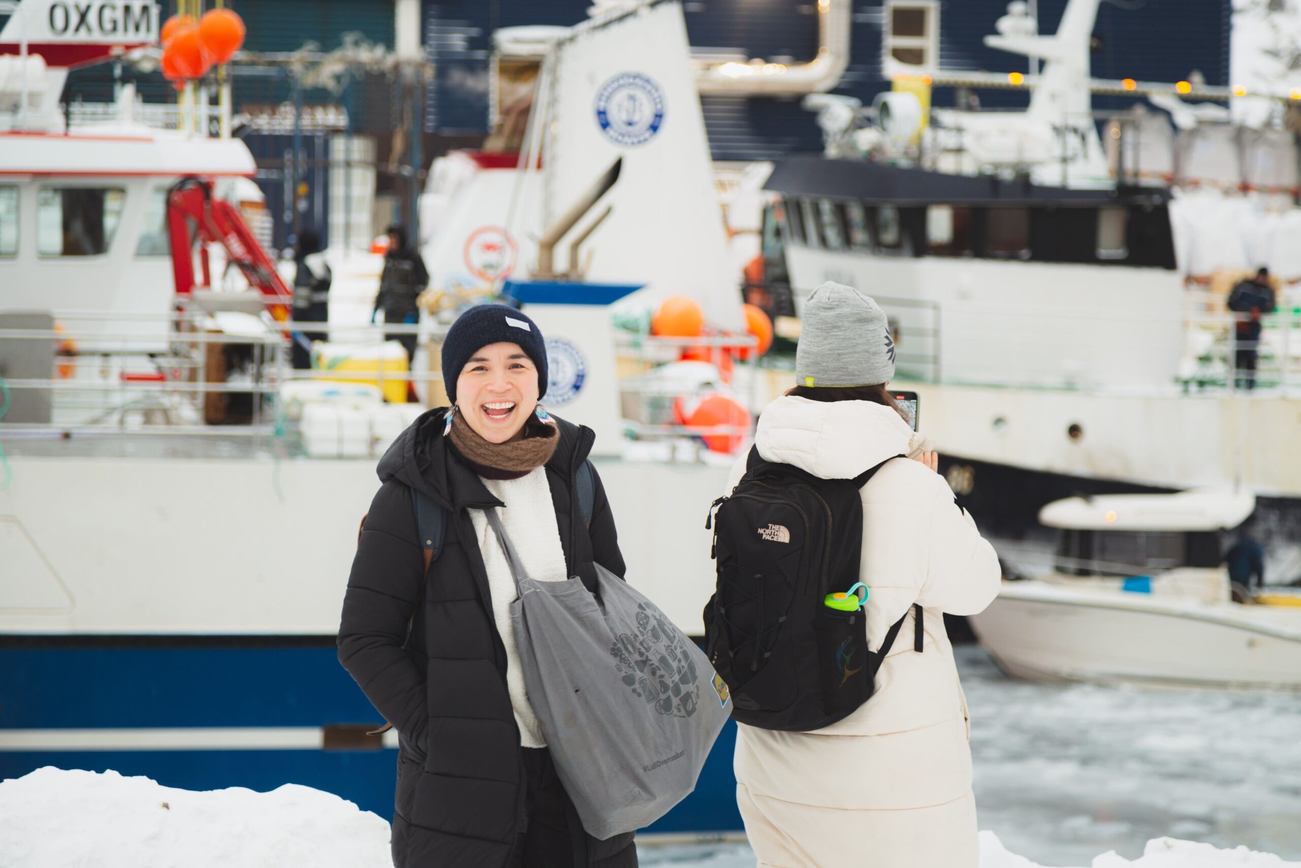 two-woman-in-the-habour-with-winter-clothes-in-nuuk