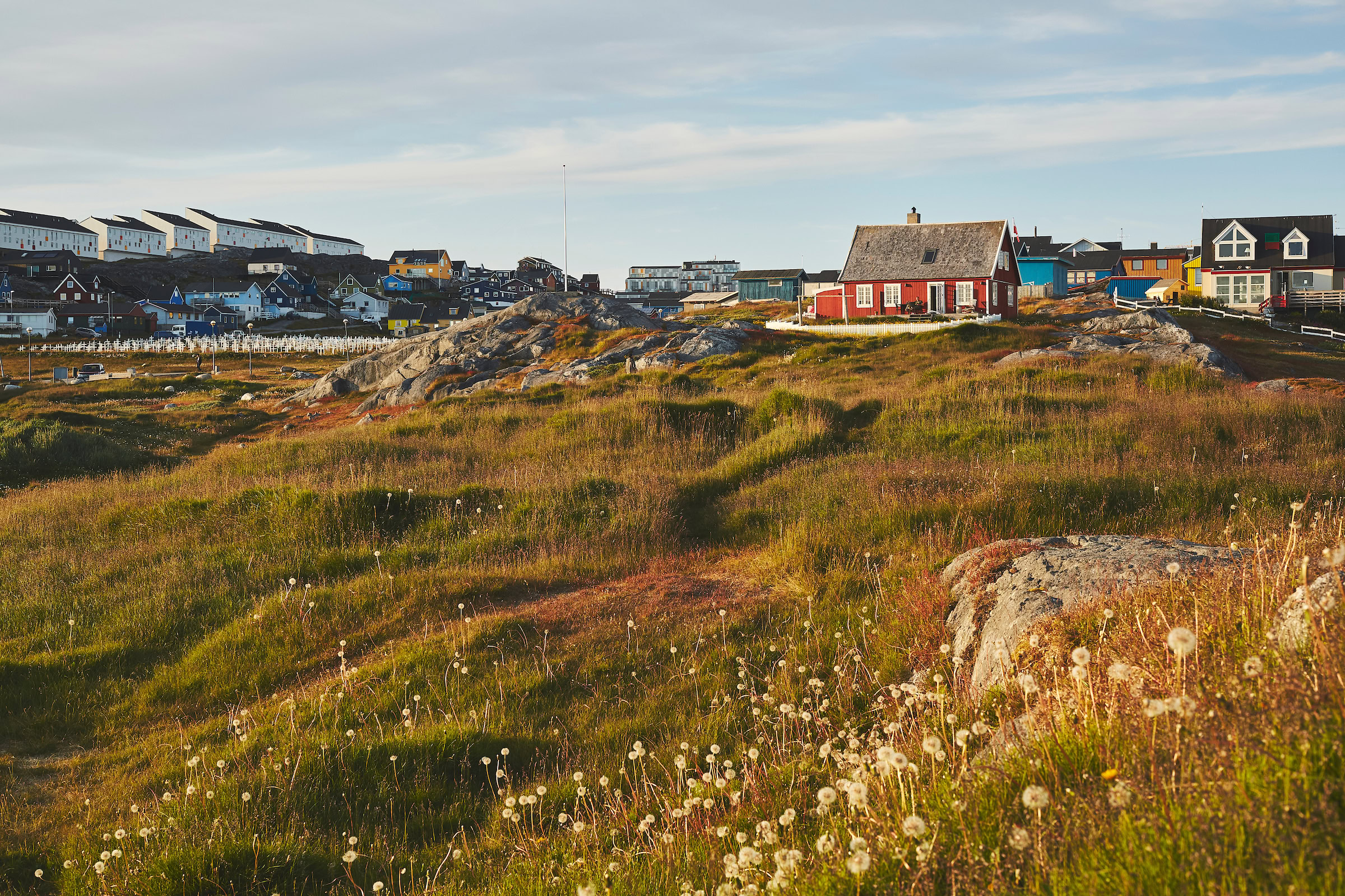 The Red House in Nuuk and its surrounding field. Photo by Peter Lindstrom - Visit Greenland